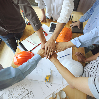 Work Group of Engineer people joining hands.(tool ,paper and Safety Helmet)