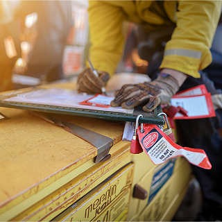 Construction worker inspects safety tags at a worksite